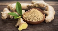 ginger powder and leaves on a wooden table