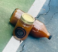 a jar of orange juice sits on a tennis court