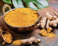 tumeric powder and leaves on a table